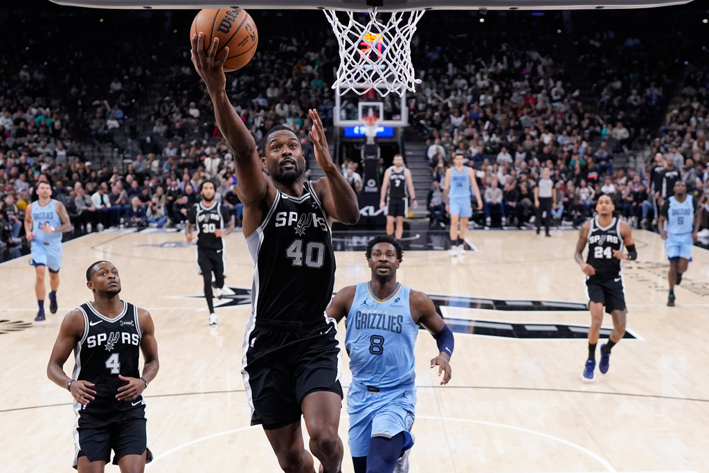 San Antonio Spurs forward Harrison Barnes (40) scores past Memphis Grizzlies forward Jaren Jackson Jr. (8) during the second half of an NBA basketball game in San Antonio, Tuesday, Dec. 2, 2025. (AP Photo/Eric Gay)