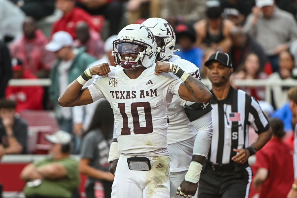 Texas A&M quarterback Marcel Reed (10) celebrates after running for a touchdown against Arkansas during the first half of an NCAA college football game Saturday, Oct. 18, 2025, in Fayetteville, Ark. (AP Photo/Michael Woods)
