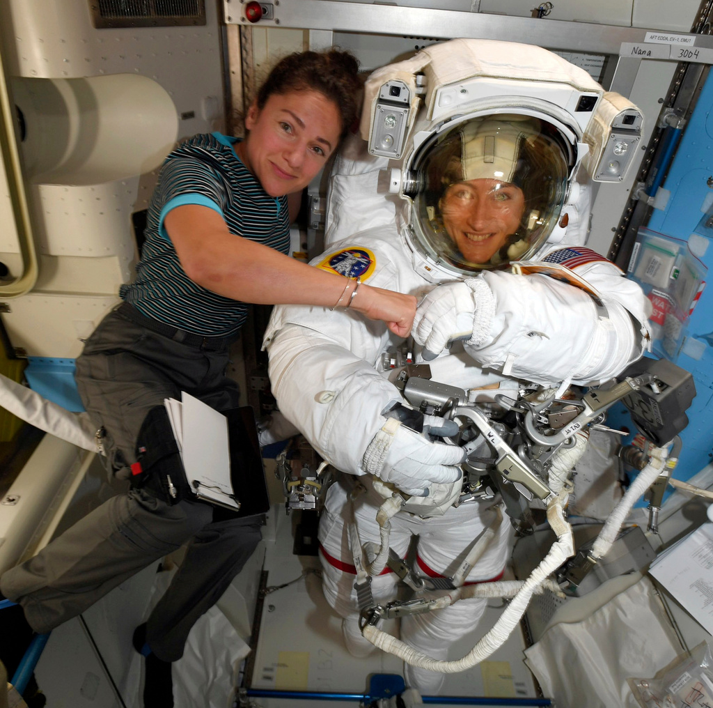 In this photo provided by NASA on Friday, Oct. 4, 2019, astronauts Christina Koch, right, and, Jessica Meir pose for a photo on the International Space Station. (NASA via AP)