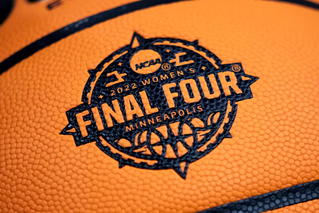 FILE - A logo is seen on a basketball during a practice session for a college basketball game in the final round of the Women's Final Four NCAA tournament April 2, 2022, in Minneapolis. (AP Photo/Charlie Neibergall, File)