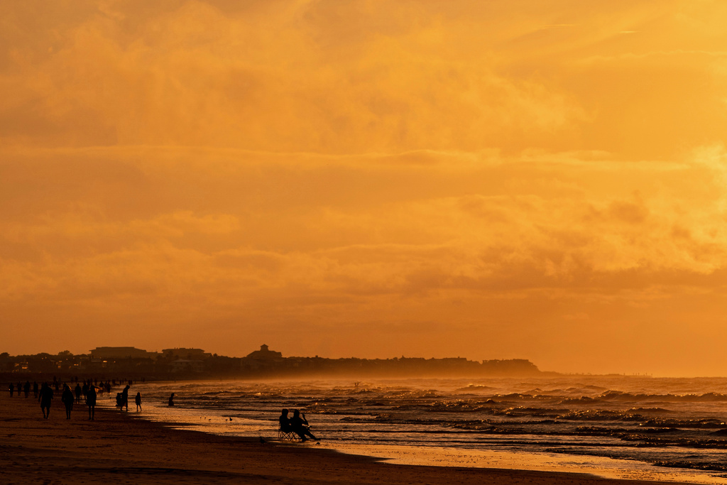 FILE - The sun rises over Isle of Palms, S.C., Aug. 13, 2022. (AP Photo/Julia Nikhinson, File)