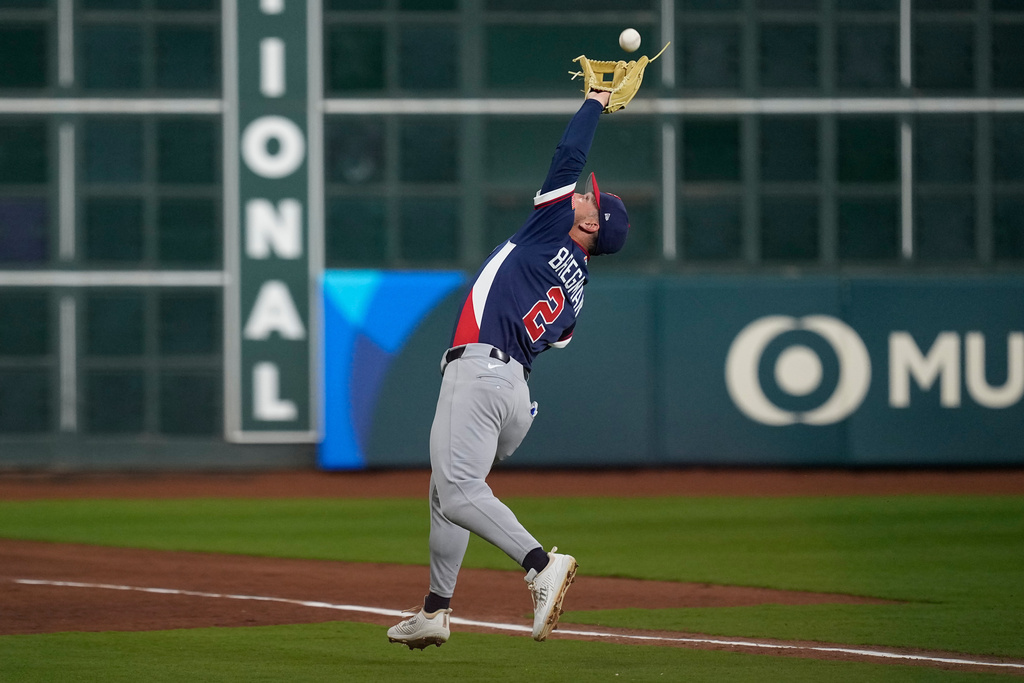 United States third baseman Alex Bregman (2) catches a pop fly by Canada first baseman Josh Naylor (12) during the first inning of a World Baseball Classic quarterfinal game, Friday, March 13, 2026, in Houston. (AP Photo/David J. Phillip)