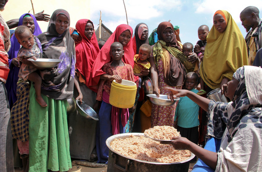 FILE - Newly arrived Somalis, displaced by a drought, receive food distributions at makeshift camps in the Tabelaha area on the outskirts of Mogadishu, Somalia on March 30, 2017. (AP Photo/Farah Abdi Warsameh, File) FILE - Newly arrived Somalis, displaced by a drought, receive food distributions at makeshift camps in the Tabelaha area on the outskirts of Mogadishu, Somalia on March 30, 2017. (AP Photo/Farah Abdi Warsameh, File)