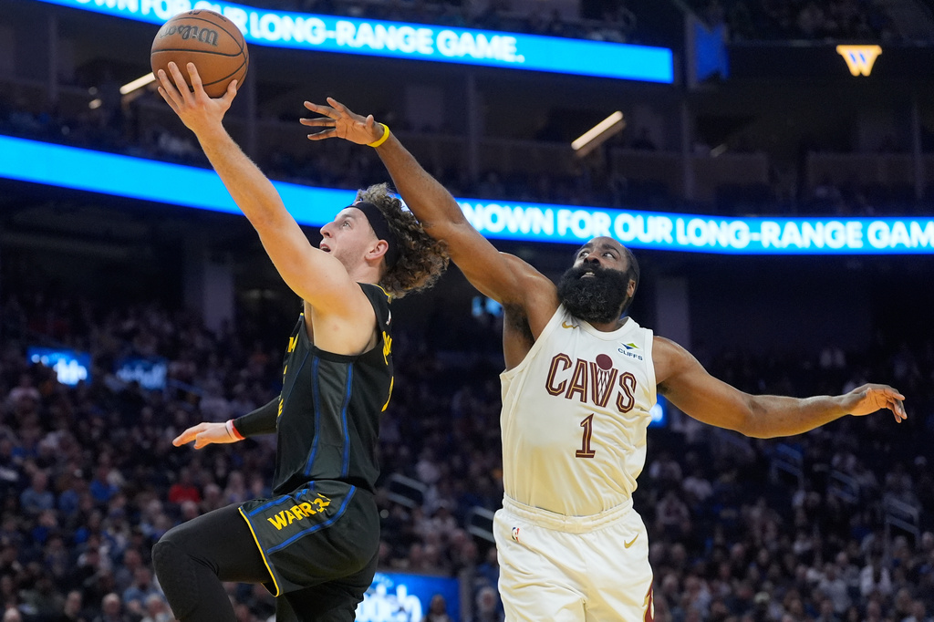 Golden State Warriors guard Brandin Podziemski, left, shoots against Cleveland Cavaliers guard James Harden during the first half of an NBA basketball game in San Francisco, Thursday, April 2, 2026. (AP Photo/Jeff Chiu)