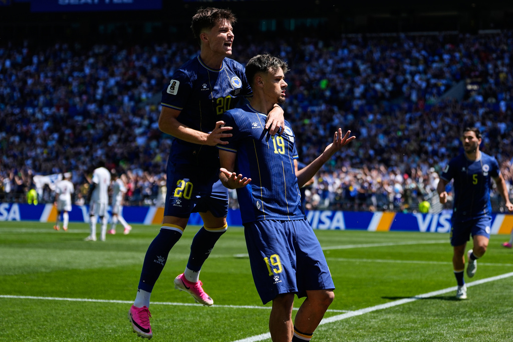 Bosnia's Kerim Alajbegovic, right, celebrates with Esmir Bajraktarevic after scoring his side's opening goal during the World Cup Group B soccer match against Qatar in Seattle, Wednesday, June 24, 2026. (AP Photo/Lindsey Wasson)
