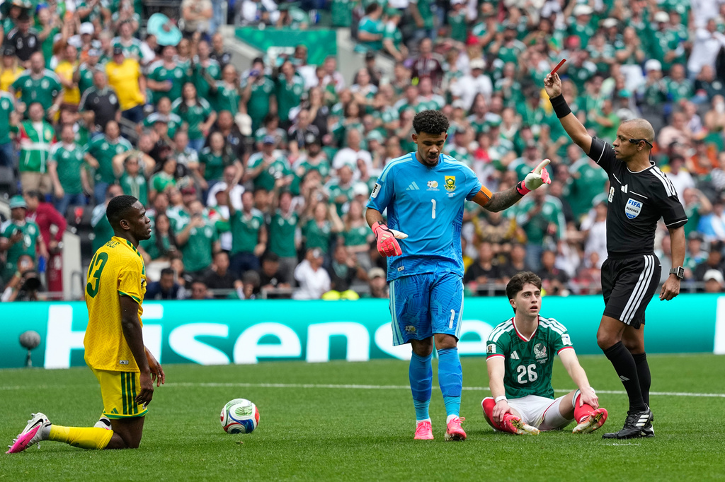Referee Wilton Sampaio a red card to South Africa's Sphephelo Sithole, left, during the World Cup Group A soccer match between Mexico and South Africa in Mexico City, Thursday, June 11, 2026. (AP Photo/Natacha Pisarenko)