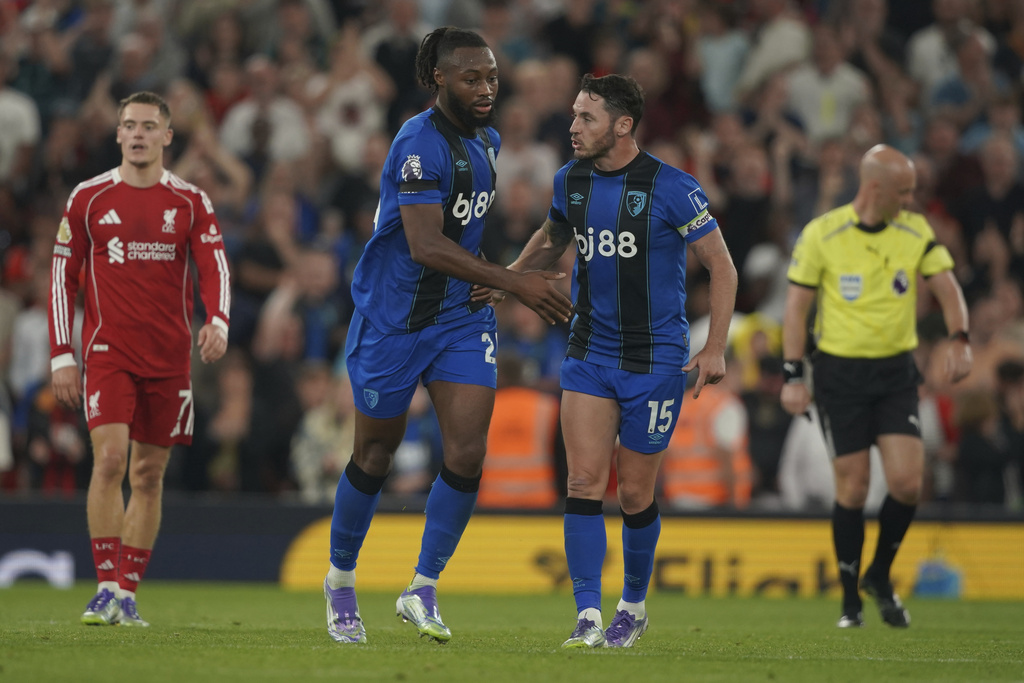 Bournemouth's Antoine Semenyo, centre left, celebrates with Bournemouth's Adam Smith after scoring his side's opening goal during the English Premier League soccer match between Liverpool and Bournemouth at Anfield stadium in Liverpool, England, Friday, Aug. 15, 2025. (AP Photo/Ian Hodgson)