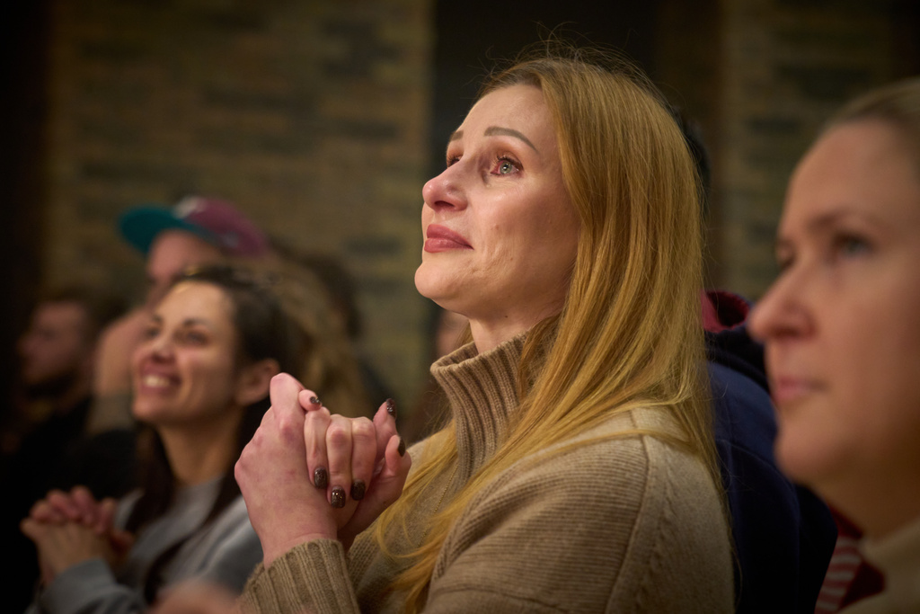 Viewers react to the premiere of an adaptation of Ivan Kotliarevskyi’s “Eneida,” a Ukrainian reimagining of Virgil’s “Aeneid,” performed by war veterans, many of whom sustained severe injuries in combat during Russia's full-scale invasion of Ukraine, in Kyiv, Ukraine, Thursday, Feb. 19, 2026. (AP Photo/Efrem Lukatsky)