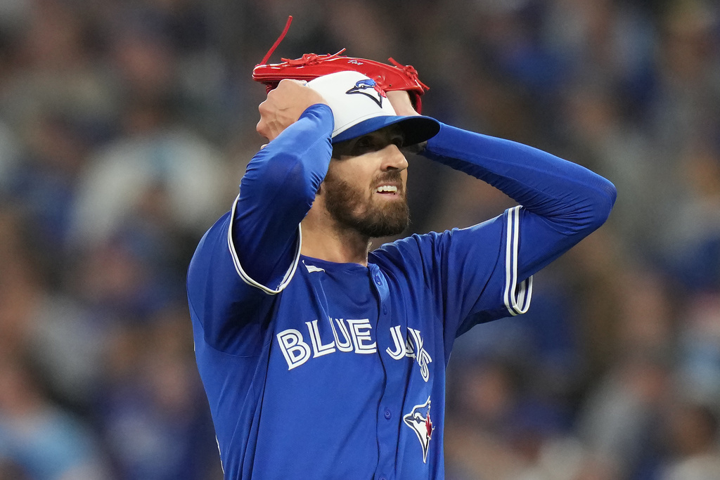 Toronto Blue Jays pitcher Kevin Gausman reacts after giving up a home run to Seattle Mariners' Cal Raleigh during the sixth inning in Game 1 of baseball's American League Championship Series in Toronto, Sunday, Oct. 12, 2025. (Chris Young/The Canadian Press via AP)