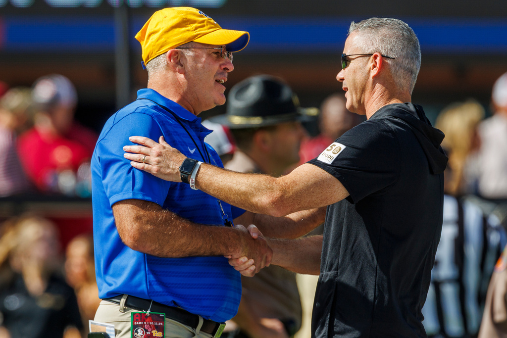 Pittsburgh head coach Pat Narduzzi, left, and Florida State head coach Mike Norvell talk prior to an NCAA college football game, Saturday, Oct. 11, 2025, in Tallahassee, Fla. (AP Photo/Colin Hackley)