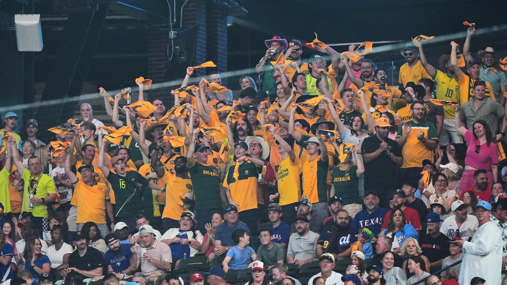 Australian soccer fans cheer in the stands during a baseball game between the Detroit Tigers and Texas Rangers, Thursday, July 2, 2026, in Arlington, Texas. (AP Photo/LM Otero)