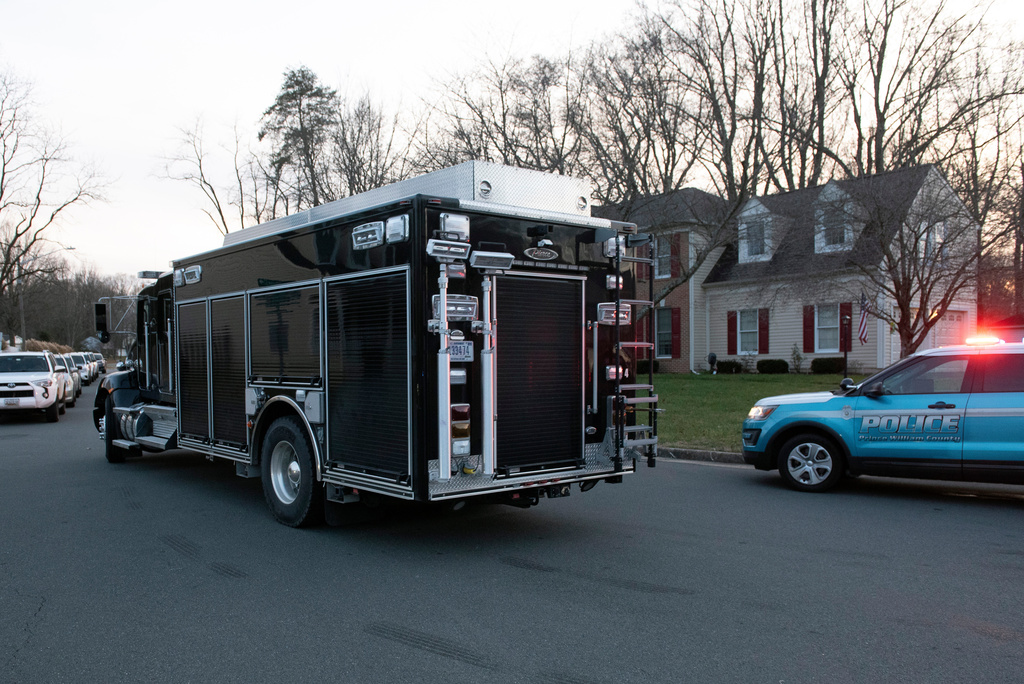 An FBI truck departs the street where the FBI made an arrest and are investigating a house in Woodbridge, Va., Thursday, Dec. 4, 2025. (AP Photo/Cliff Owen)