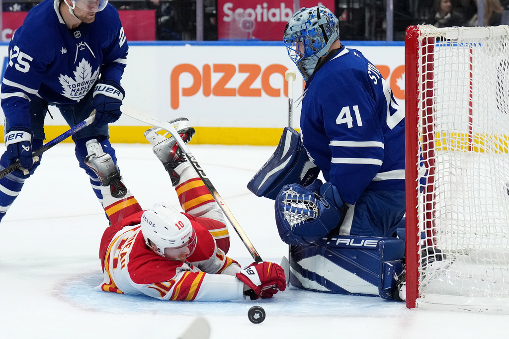 Toronto Maple Leafs goaltender Anthony Stolarz (41) makes a save on Calgary Flames forward Jonathan Huberdeau (10) during the first period of a NHL hockey game in Toronto, Tuesday, Oct. 28, 2025. (Nathan Denette/The Canadian Press via AP)