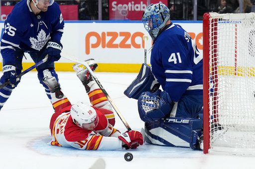 Toronto Maple Leafs goaltender Anthony Stolarz (41) makes a save on Calgary Flames forward Jonathan Huberdeau (10) during the first period of a NHL hockey game in Toronto, Tuesday, Oct. 28, 2025. (Nathan Denette/The Canadian Press via AP) Toronto Maple Leafs goaltender Anthony Stolarz (41) makes a save on Calgary Flames forward Jonathan Huberdeau (10) during the first period of a NHL hockey game in Toronto, Tuesday, Oct. 28, 2025. (Nathan Denette/The Canadian Press via AP)