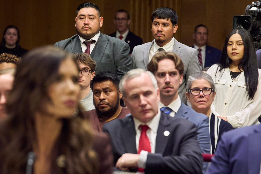 FILE - Homeland Security Secretary Kristi Noem, front left, listens as three U.S. citizens who had been detained by ICE stand, from back left, Javier Ramirez, of Calif., Leonardo "Leo" Garcia Venegas, of Ala., and Marimar Martinez, of Chicago, as they are introduced by Sen. Richard Blumenthal, D-Ct., during an oversight hearing before the Senate Judiciary Committee, on Capitol Hill in Washington, March 3, 2026. (AP Photo/Jacquelyn Martin, File)
