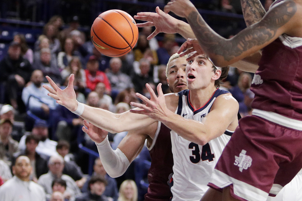 Gonzaga forward Braden Huff (34) and Texas Southern center Jordan Gorecki go after a rebound during the first half of an NCAA college basketball game, Monday, Nov. 3, 2025, in Spokane, Wash. (AP Photo/Young Kwak)