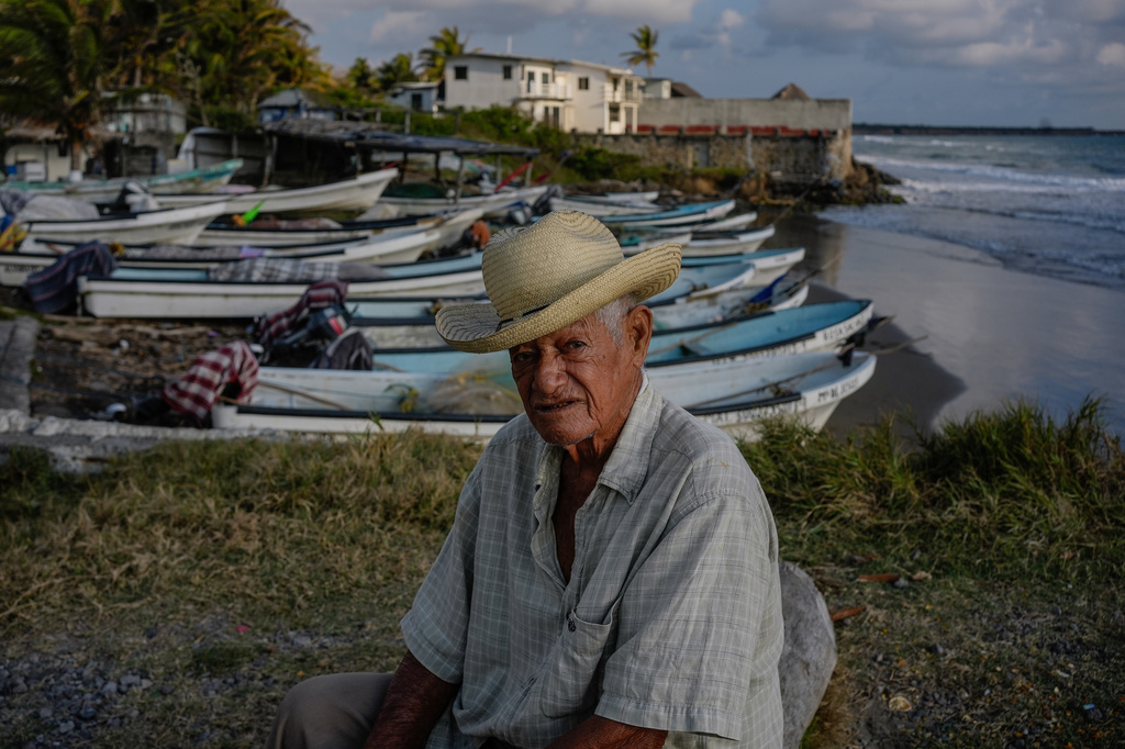 Fisherman Roberto Santos sits on the shore after suspending fishing because of an oil spill in the Gulf of Mexico that authorities said originated from an unidentified vessel and two natural oil seeps in Salinas, Mexico, Thursday, March 26, 2026. (AP Photo/Felix Marquez)