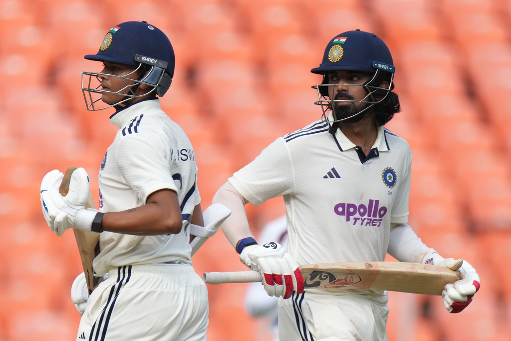 India's KL Rahul, right, and Yashasvi Jaiswal, center, run between the wickets to score on the first day of the first Test cricket match between India and West Indies at Narendra Modi Stadium in Ahmedabad, India, Thursday, Oct. 2, 2025. (AP Photo/Ajit Solanki)