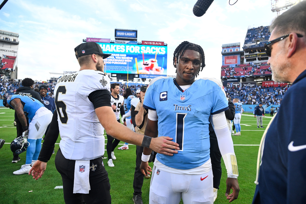 New Orleans Saints quarterback Tyler Shough (6) greets Tennessee Titans quarterback Cam Ward (1) after an NFL football game, Sunday, Dec. 28, 2025, in Nashville, Tenn. (AP Photo/John Amis)