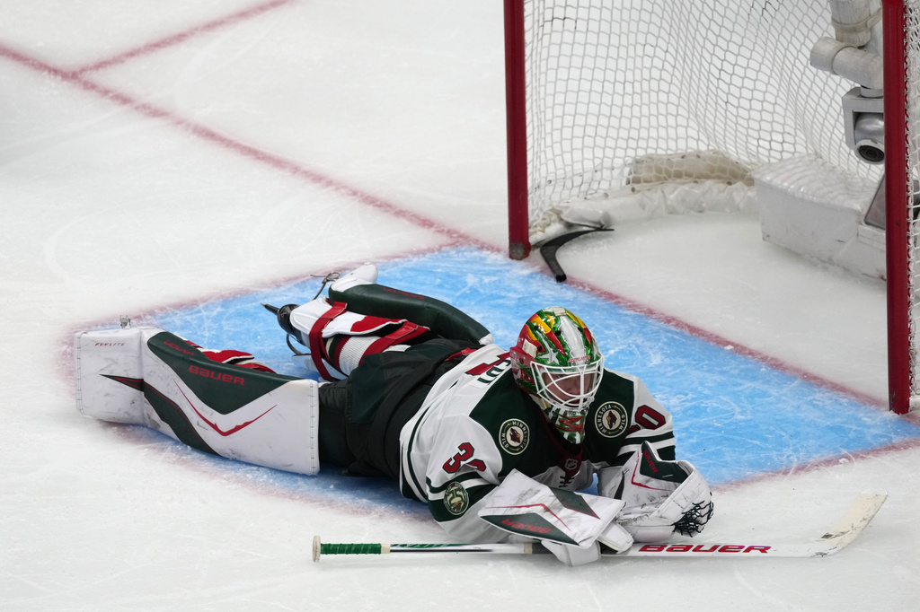 Minnesota Wild goaltender Jesper Wallstedt reacts after allowing the winning goal on a shot by Colorado Avalanche defenseman Brett Kulak in overtime of Game 5 of an NHL Stanley Cup hockey second-round playoff series Wednesday, May 13, 2026, in Denver. (AP Photo/David Zalubowski)