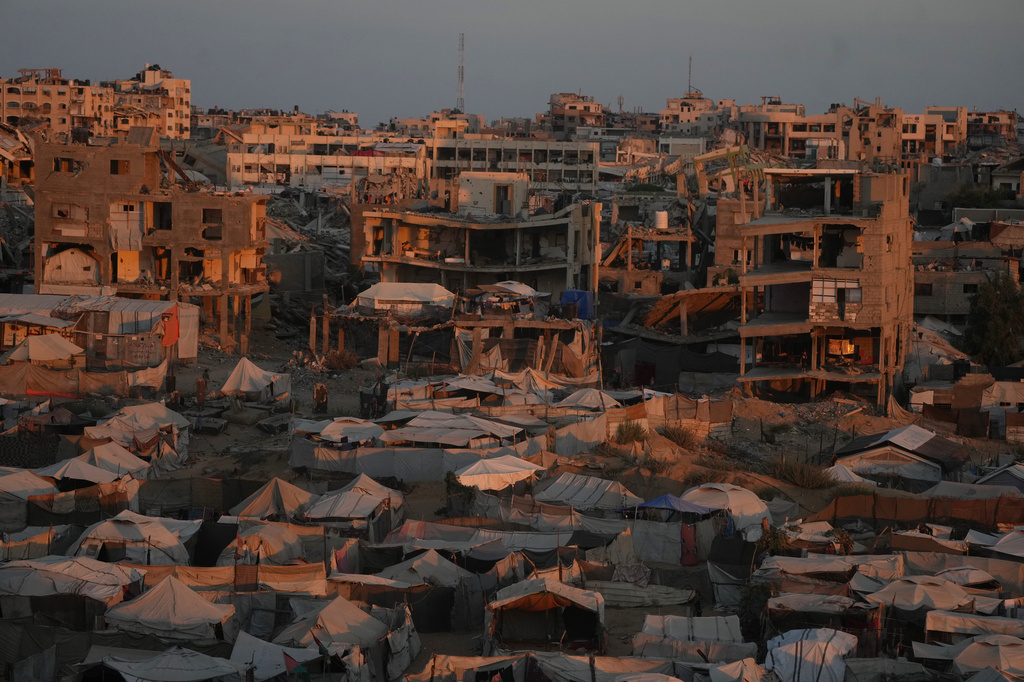 Tents sheltering displaced Palestinians are seen amid war-damaged buildings in Gaza City, Saturday, Sept. 26, 2026. (AP Photo/Jehad Alshrafi)