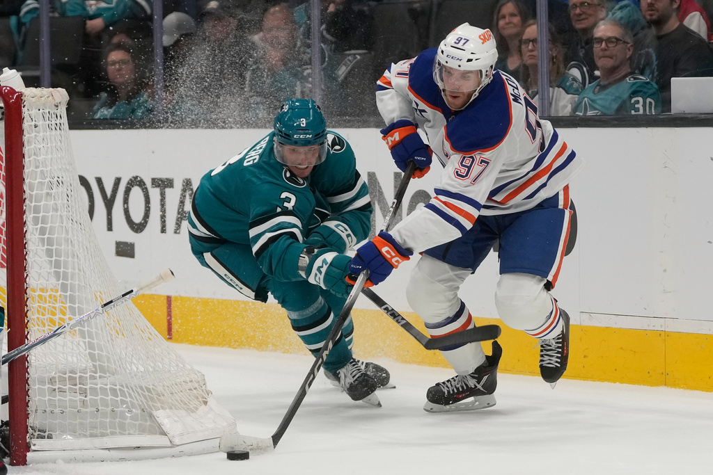 Edmonton Oilers center Connor McDavid (97) skates with the puck against San Jose Sharks defenseman John Klingberg during the second period of an NHL hockey game in San Jose, Calif., Saturday, Feb. 28, 2026. (AP Photo/Jeff Chiu)