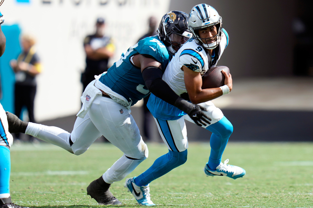 Jacksonville Jaguars defensive end Dawuane Smoot, left, sacks Carolina Panthers quarterback Bryce Young (9) during the second half of an NFL football game, Sunday, Sept. 7, 2025, in Jacksonville, Fla. (AP Photo/John Raoux)