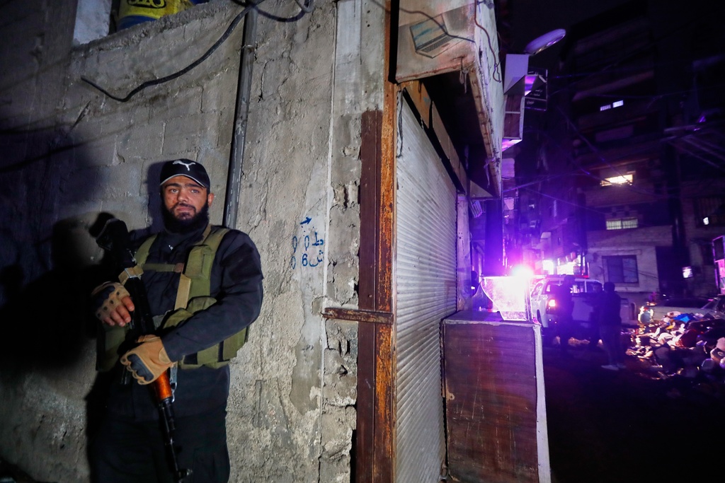 Syrian security forces secure the area around a building that, according to state media, was hit by rockets Friday, Nov. 14, 2025. It was not immediately clear who was behind the attack. (AP Photo/Omar Sanadiki)