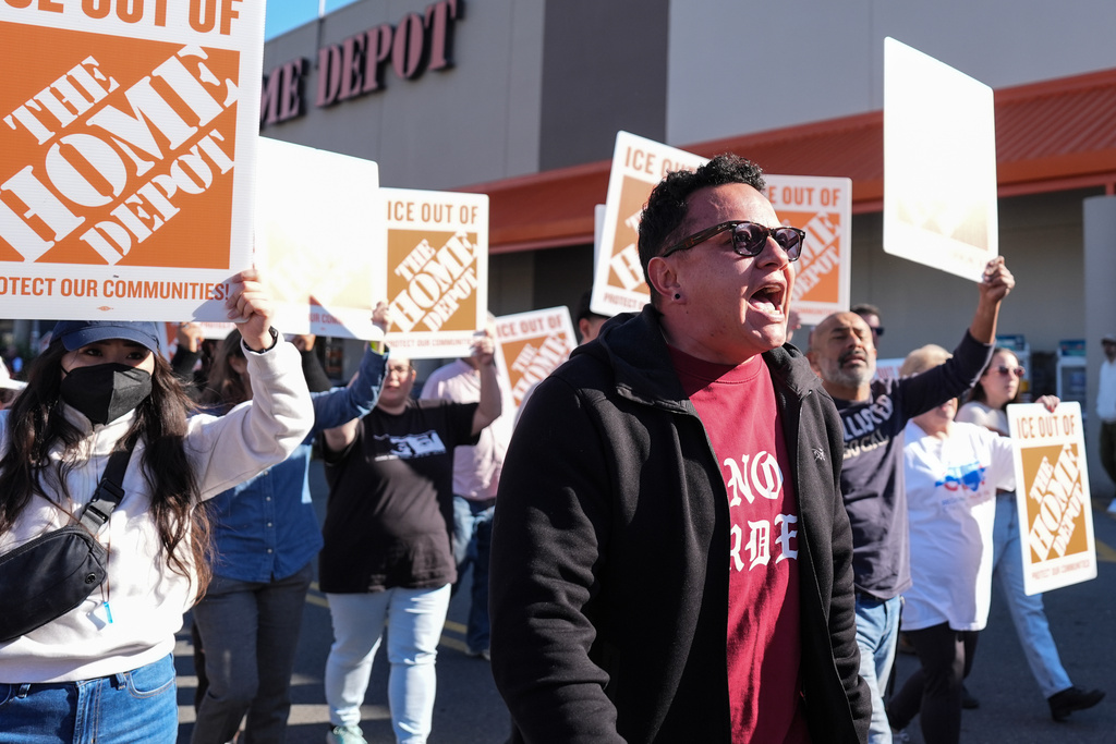 Organizing director for the National Day Laborer Organizing Network Jorge Torres, center, marches alongside protestors outside of a Home Depot, Wednesday, Nov. 19, 2025, in Charlotte, N.C. (AP Photo/Matt Kelley)