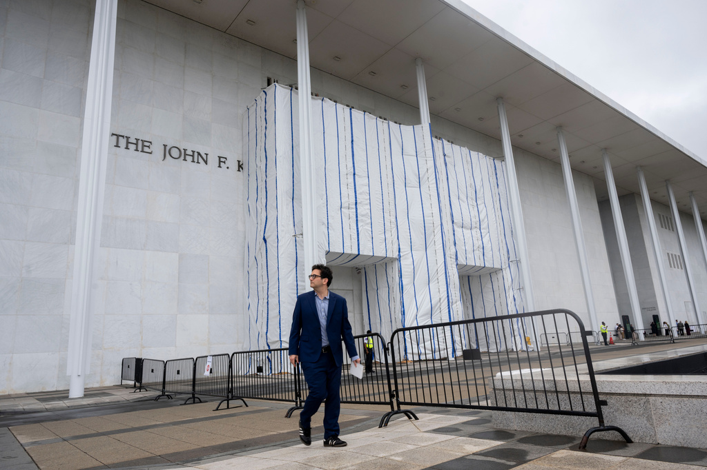 People walk near the tarp covered front entrance of the Kennedy Center for the Performing Arts before the start of the 27th Annual Mark Twain Prize for American Humor Celebrating Bill Maher, Sunday, June 29, 2026, in Washington. (AP Photo/Kevin Wolf)