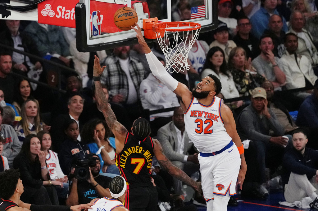 New York Knicks' Karl-Anthony Towns (32) blocks a shot by Atlanta Hawks' Nickeil Alexander-Walker (7) during the first half in Game 1 of a first-round NBA playoffs basketball series, Saturday, April 18, 2026, in New York. (AP Photo/Frank Franklin II)