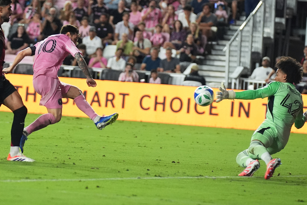 Inter Miami forward Lionel Messi (10) attempts a shot on the goal as Atlanta United goalkeeper Jayden Hibbert (42) defends during the first half of an MLS soccer match, Saturday, Oct. 11, 2025, in Fort Lauderdale, Fla. (AP Photo/Lynne Sladky)