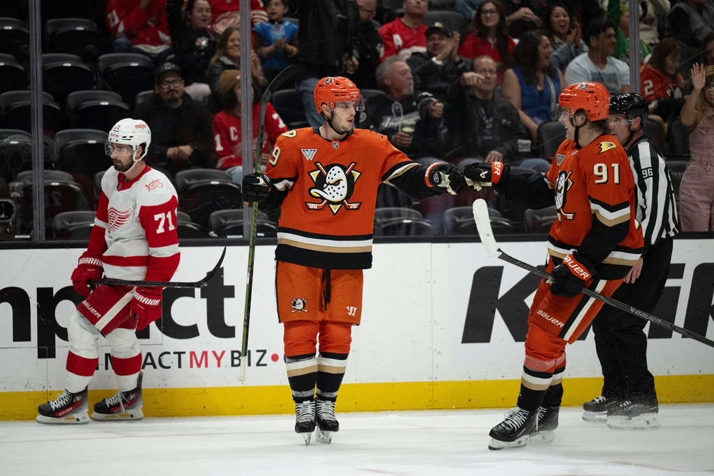 Anaheim Ducks right wing Troy Terry (19) celebrates his empty-net goal with center Leo Carlsson (91) during the third period of an NHL hockey game against the Detroit Red Wings, Friday, Oct. 31, 2025, in Anaheim, Calif. (AP Photo/Kyusung Gong)