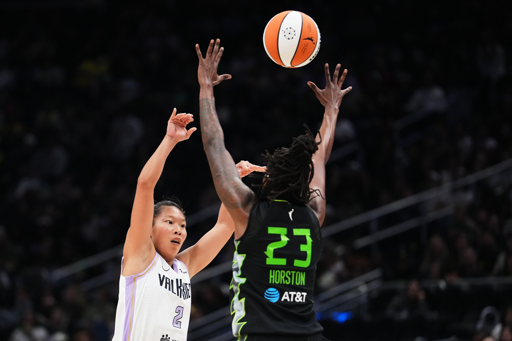 Golden State Valkyries guard Kaitlyn Chen passes through the arms of Seattle Storm guard Jordan Horston (23) during the first half of a WNBA basketball game, Friday, May 8, 2026, in Seattle. (AP Photo/Lindsey Wasson)