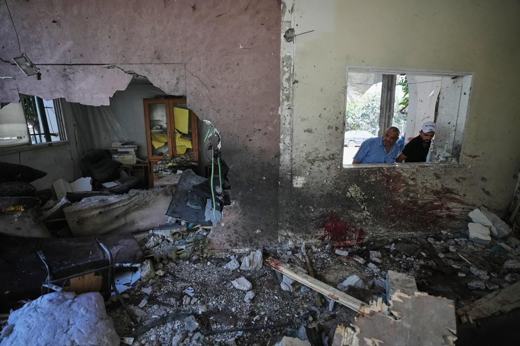 Palestinians inspect the damage at a police station that was hit by an Israeli airstrike in Gaza City, Wednesday, Aug. 19, 2026. (AP Photo/Jehad Alshrafi)