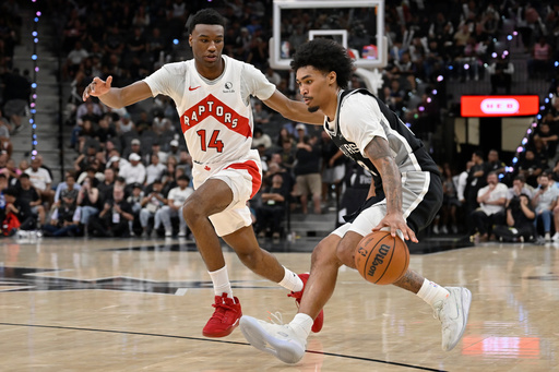 San Antonio Spurs guard Dylan Harper, right, drives against Toronto Raptors guard Ja'Kobe Walter (14) during the second half of an NBA basketball game, Monday, Oct. 27, 2025, in San Antonio. (AP Photo/Darren Abate) San Antonio Spurs guard Dylan Harper, right, drives against Toronto Raptors guard Ja'Kobe Walter (14) during the second half of an NBA basketball game, Monday, Oct. 27, 2025, in San Antonio. (AP Photo/Darren Abate)
