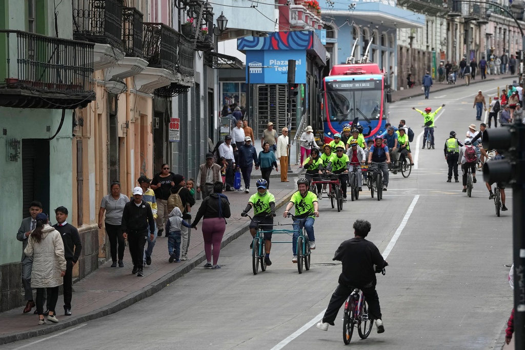 FILE - Volunteers with the "Ciegocleta" initiative guide visually impaired participants on tandem bicycles in Quito, Ecuador, Sunday, Aug. 30, 2026. (AP Photo/Dolores Ochoa)
