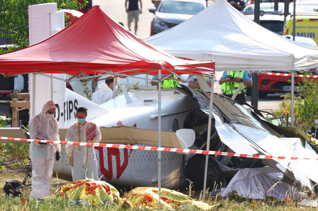 Forensic technicians examine a skydiving plane that crashed in Tomblaine northeastern France, killing all 11 people on board, Sunday, June 28, 2026. (AP Photo/Antonin Utz)