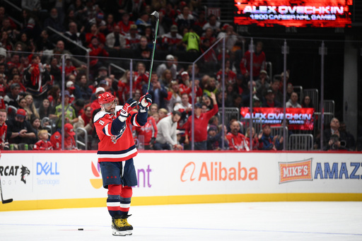 Washington Capitals left wing Alex Ovechkin (8) raises his stick to the crowd after he was recognized for playing in his 1,500th NHL hockey game during a break in the action in the first period against the Ottawa Senators, Saturday, Oct. 25, 2025, in Washington. (AP Photo/Nick Wass) Washington Capitals left wing Alex Ovechkin (8) raises his stick to the crowd after he was recognized for playing in his 1,500th NHL hockey game during a break in the action in the first period against the Ottawa Senators, Saturday, Oct. 25, 2025, in Washington. (AP Photo/Nick Wass)