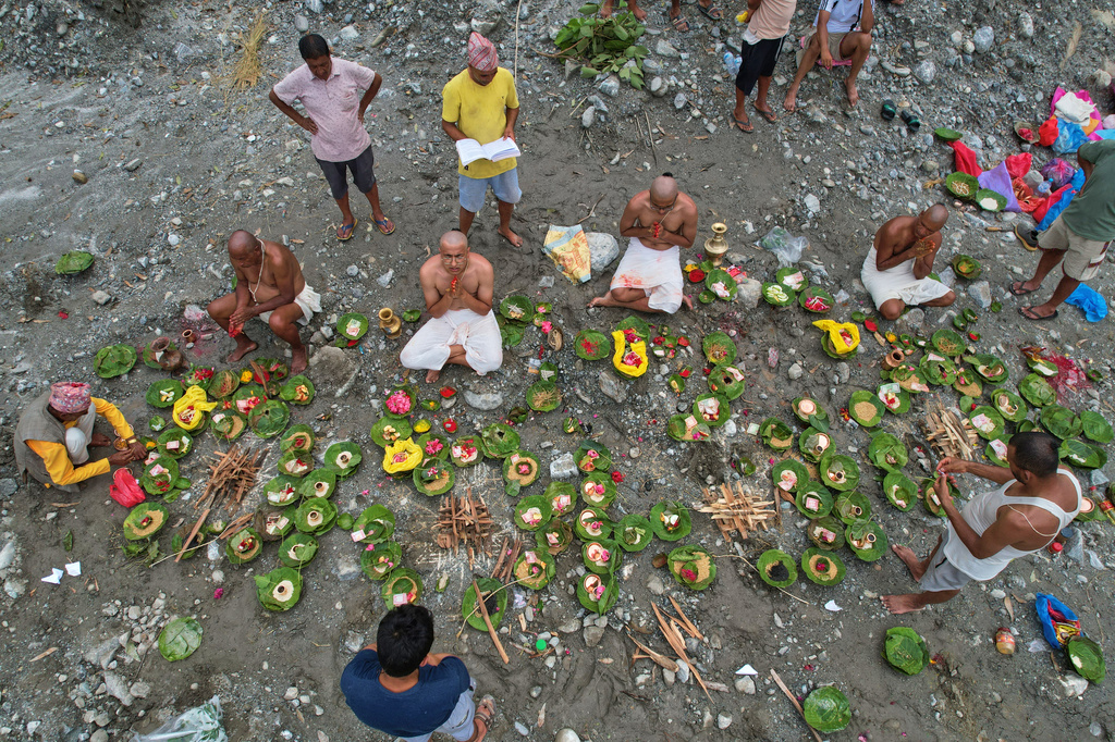 People whose relatives remain missing following flash floods perform rituals after symbolic funeral rites on the banks of the swollen Trishuli River in Nepal's Nuwakot district, Wednesday, Sept. 2, 2026. (AP Photo/Rajesh Kumar Singh)