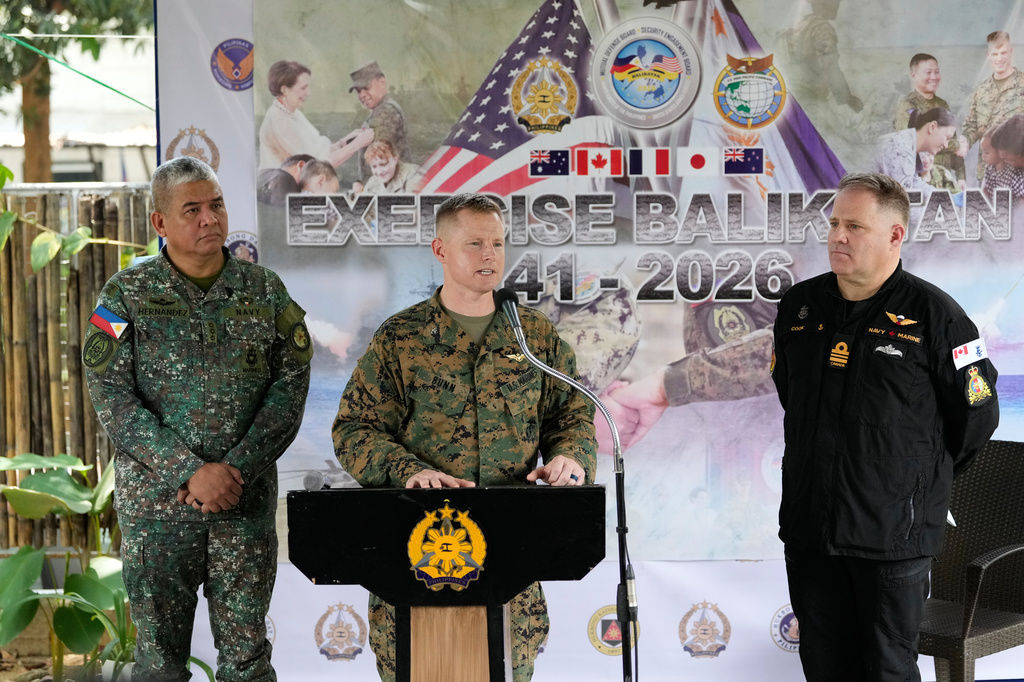 U.S. Col. Robert Bunn, center, speaks beside Philippine Navy Col. Dennis Hernandez, left, and Canada Navy Lt. Commander Craig Cook during a press conference for the upcoming joint military exercise dubbed "Balikatan" or "Shoulder to Shoulder" at Camp Aguinaldo military headquarters on Tuesday, April 14, 2026, in Quezon city, Philippines. (AP Photo/Aaron Favila)