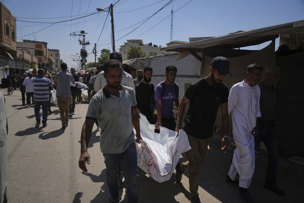 Palestinians carry the body of Aliya Abu Ouda, 37, killed in an Israeli airstrike on the Gaza Strip, in Deir al-Balah, Sunday, Sept. 14, 2025.(AP Photo/Abdel Kareem Hana)