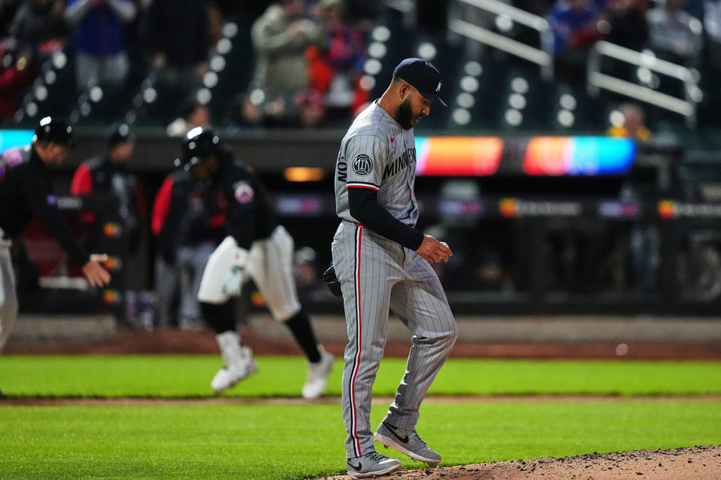 Minnesota Twins pitcher Simeon Woods Richardson, right, reacts as New York Mets' Francisco Lindor runs the bases after hitting a three-run home run during the third inning of a baseball game Tuesday, April 21, 2026, in New York. (AP Photo/Frank Franklin II)