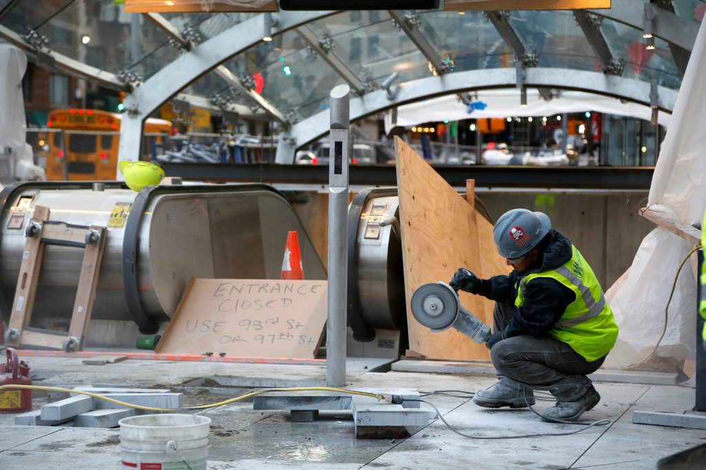 FILE - A construction worker cuts stone near an entrance of the unfinished Second Avenue subway, Dec. 14, 2016, in New York. (AP Photo/Seth Wenig, File)