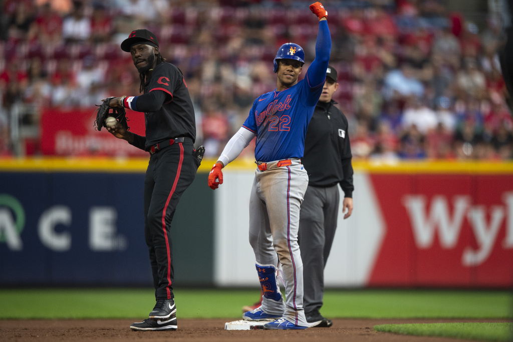 New York Mets' Juan Soto (22) celebrates after hitting a double in the third inning of a baseball game against the Cincinnati Reds, Friday, Sept. 5, 2025, in Cincinnati. (AP Photo/Michael Swensen)