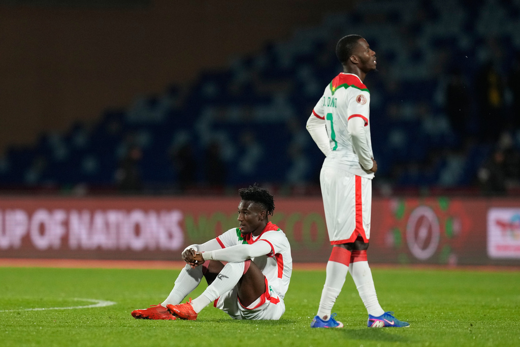 Burkina Faso's Ousseni Bouda sits on th epitch after the Africa Cup of Nations best of 16 soccer match between Ivory Coast and Burkina Faso in Marrakech, Morocco, Tuesday, Jan. 6, 2026. (AP Photo/Themba Hadebe)