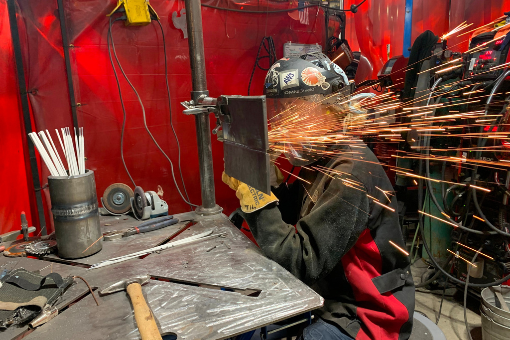 Student Mikala Sposito welds at Washtenaw Community College on Friday, May 1, 2026, in Ann Arbor., Mich. (AP Photo/Mike Householder)