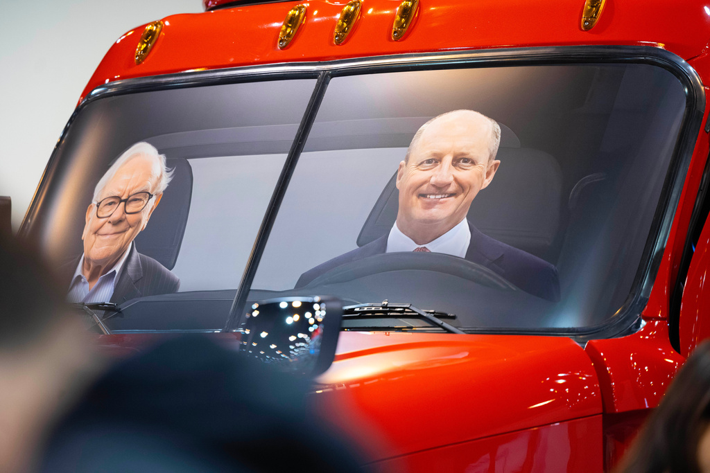 FILE - Portraits of Berkshire Hathaway's Warren Buffett, left, and CEO Greg Abel sit in a semi truck at the Pilot display in the Berkshire Hathaway annual meeting on May 2, 2026, in Omaha, Neb. (AP Photo/Rebecca S. Gratz, file)