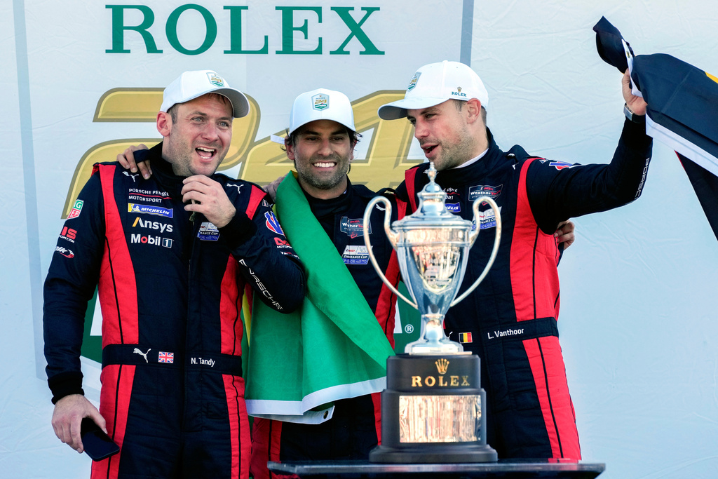 FILE - Porsche Penske Motorsport team members, from left to right, Britain's Nick Tandy, Brazil's Felipe Nasr and Belgium's Laurens Vanthoor celebrate after winning the IMSA Rolex 24 hour auto race at Daytona International Speedway, Sunday, Jan. 26, 2025, in Daytona Beach, Fla. (AP Photo/John Raoux, file)