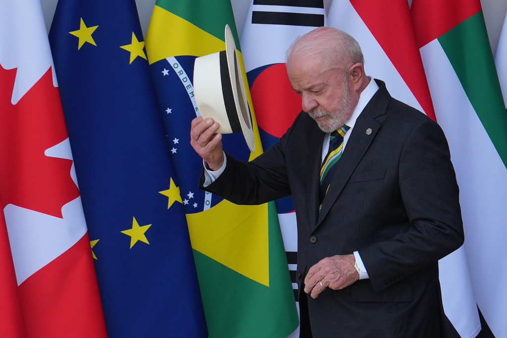 Brazil's President Luiz Inacio Lula da Silva walks past flags during at the G7 summit, Tuesday, June 16, 2026, in Evian-les-Bains, France. (AP Photo/Julia Demaree Nikhinson)